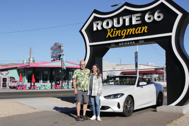 Murray and Andrea with their BMW convertible at the Route 66 Arch in Kingman, Arizona.