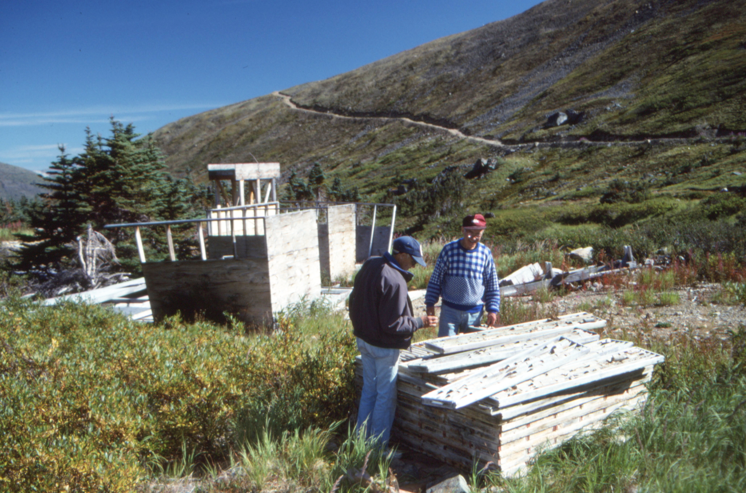 John Scott and Gord Ryder inspect the drill core trays on the Uranus claim, Montana Mountain, Yukon.