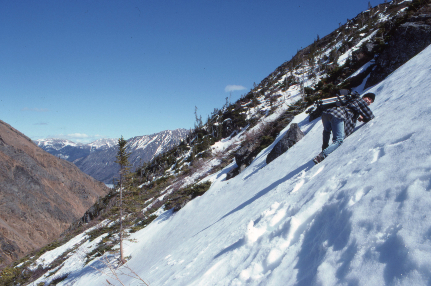 Simon Hutton climbing back up after a failed attempt to get down into Pooley Canyon.
