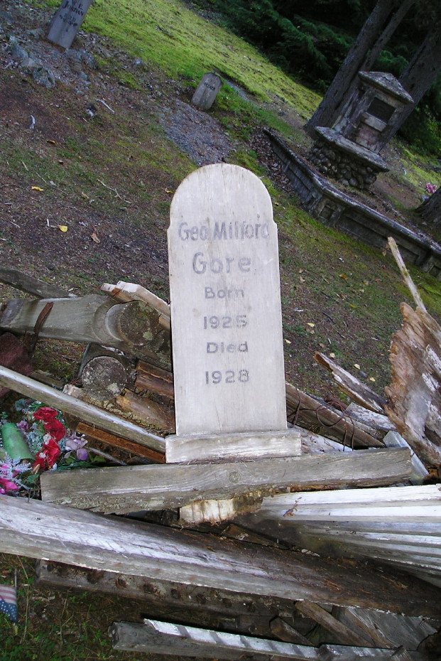 Headboard for George Milford Gore in a scrap pile in the Pioneer Cemetery at Skagway, Alaska