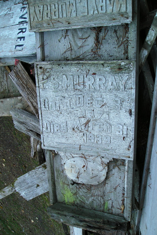 Headboard for P. S. Murray in a scrap pile in the Pioneer Cemetery at Skagway, Alaska