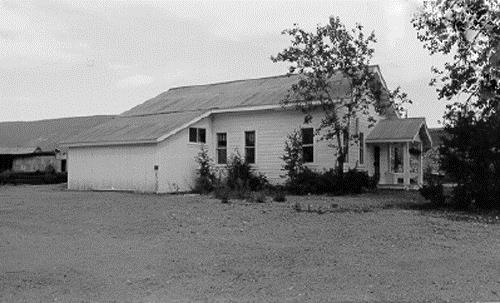 View of the exterior of the Gold Room at Bear Creek, showing its residential character despite its key industrial function, 1988. Photo by Parks Canada.
