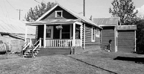 View of the Staff House, showing its distinctive log construction, 1988. Photo by Parks Canada.