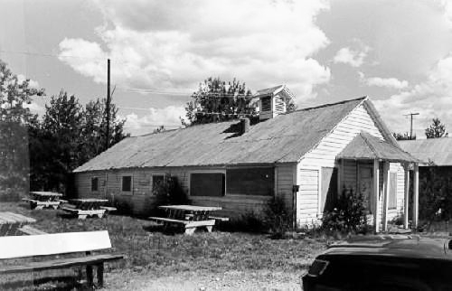 Corner view of the Engineering Office (Building 19) at Bear Creek, showing its horizontal wood siding and its rooftop ventilator, 1988. Photo by Parks Canada.