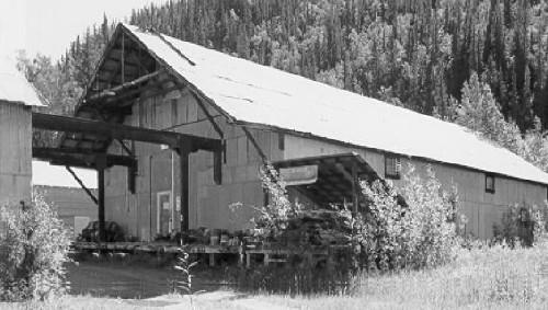 Corner view of Warehouse 2, showing the building's simple, warehouse form and massing including the gable roof, 1988. Photo by Parks Canada.