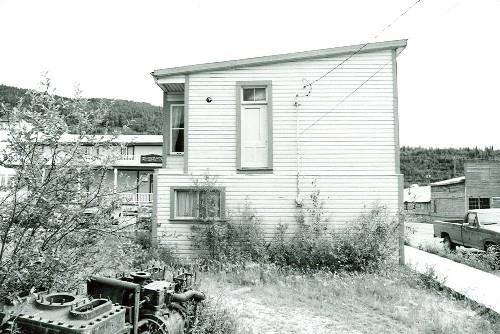 Rear facade of Harrington's Store, showing the wood frame construction, 1987. Photo by Department of the Environment.