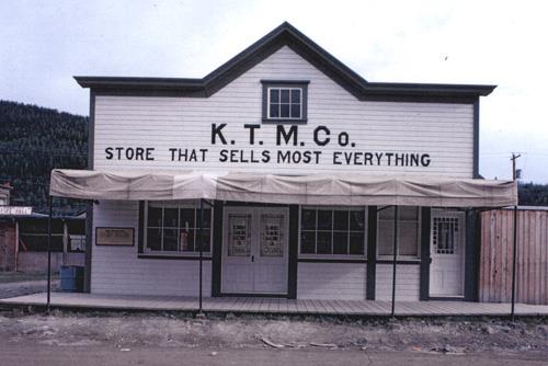 General view of the KTM Building, showing the painted, decorative, two-and-a-half-bay retail facade with large retail windows, double entrance door and single door to the side, and its irregular arrangement of large retail windows, 1987.