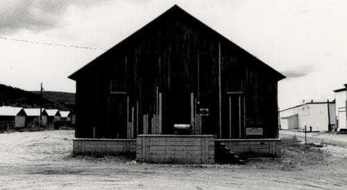 View of the Northern Commercial Company Warehouse, showing the double door flanked by small windows on the end elevations, 1987. Photo by Parks Canada.