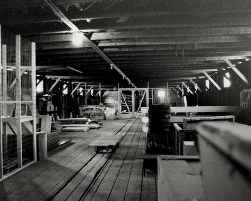 View of the Northern Commercial Company Warehouse, showing the interior central tramway feature to facilitate the storage and retrieval of goods in the warehouse, 1987. Photo by Parks Canada.