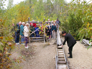 A tour guide explains the workings of a placer claim that has gone underground. Photo by Murray Lundberg, August 30, 2002.