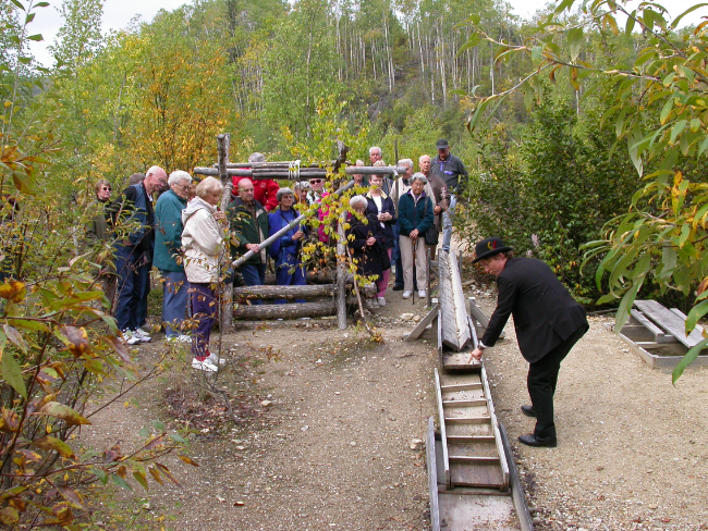A tour guide explains the workings of a placer claim that has gone underground. Photo by Murray Lundberg, August 30, 2002. 