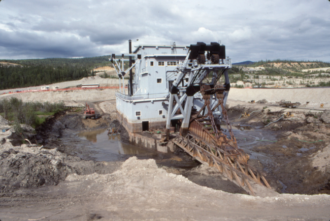 Working to float or at least level Dredge No. 4, in July 1991. Photo by Murray Lundberg.