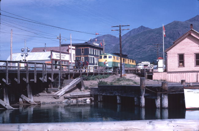 Carcross, Yukon, on July 4, 1967. Photo by Terry Danks. Note the vehicles on flatcars headed for Skagway as there was no road yet.