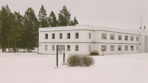 Corner view of Building 200, showing the evenly spaced, long rectangular windows of the wings and narrow rectangular windows of the recessed ends, 1991. Photo by Public Works Canada.