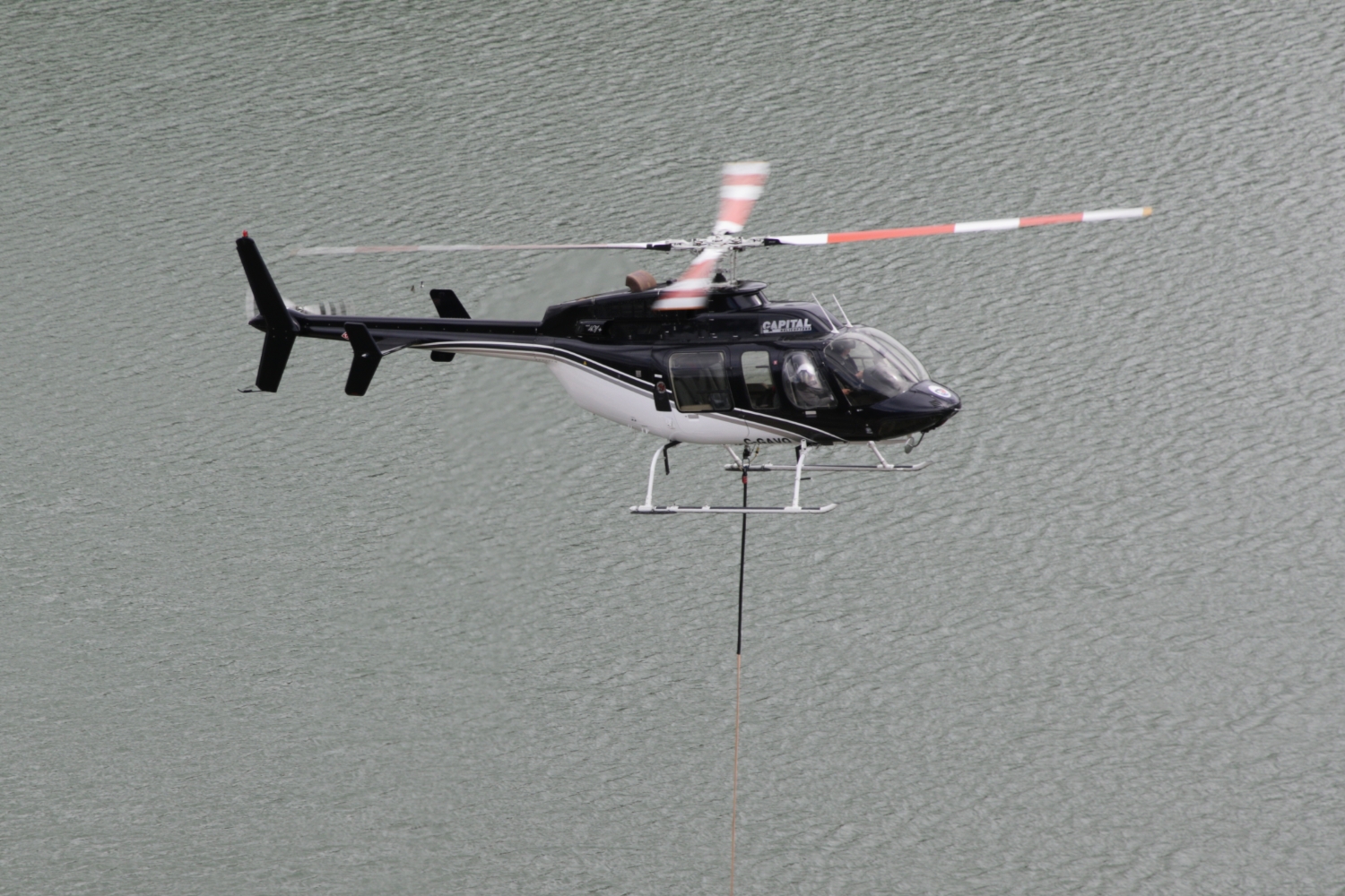 C-GAVQ, Capital Helicopters' Bell 407, doing fire bucket practice at Schwatka Lake, Whitehorse, Yukon, on May 6, 2026.