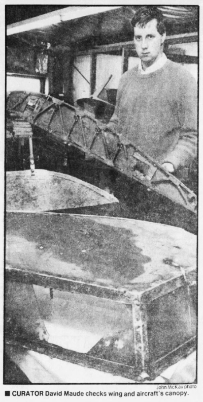 Photo: Museum curator Davis Maude checks out aircraft's wing and canoppy, 1988