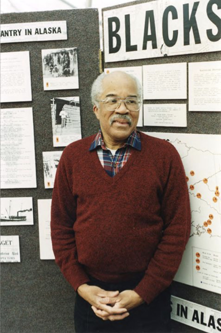 George Harper in front of his 'Blacks and the Gold Rush' exhibit at the Z.J. Loussac Public Library in about 1997.