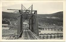 A historic postcard showing the WP&YR railway bridge at Carcross, probably in the early 1950s.