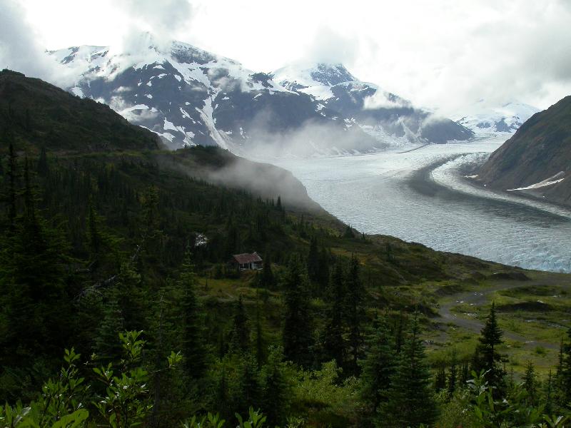 A photo by Murray Lundberg, showing a log cabin overlooking the huge Salmon Glacier in remote northern British Columbia.