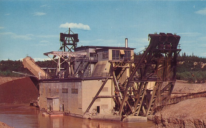 A historic photo of a gold dredge operating in Alaska.