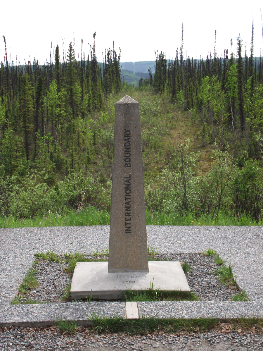 The Canada/USA boundary marker and cut-line on the Alaska Highway
