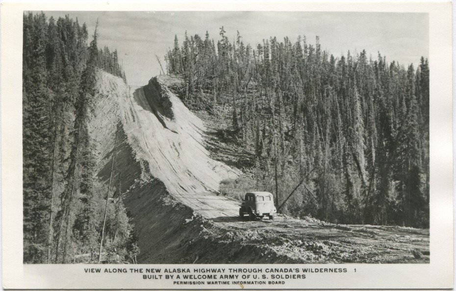 Postcard showing an Army carryall about to climb a very steep dirt hill on the new Alaska Highway in the 1940s