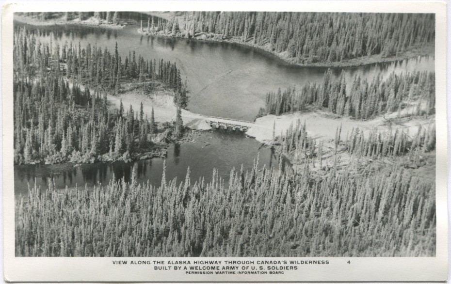 An aerial view of a small bridge on the new Alaska Highway in the 1940s