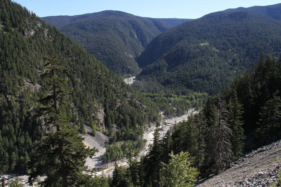 At Km 16.5 going down the Bella Coola hill, a bridge on the Atnarko Glacier Road can be seen far below.