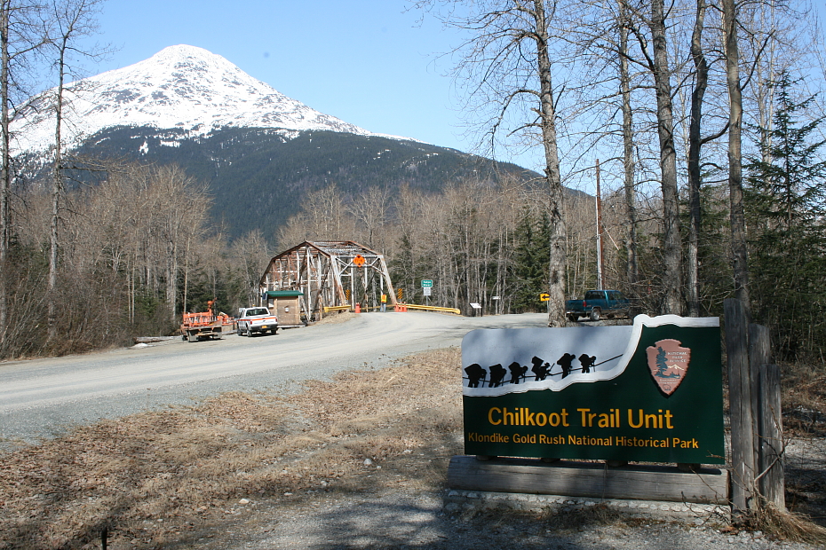 The Chilkoot Trail sign and Taiya River Bridge on the Dyea Road