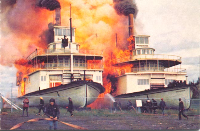 The sternwheelers 'Casca' and 'Whitehorse' burning alongside the Yukon River