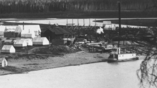 The sternwheeler 'F. H. Kilbourne' at King's Mill, on the Nares River at Caribou Crossing (Carcross), Yukon, ca.1899. Lake Bennett is a half-mile to the left (south)