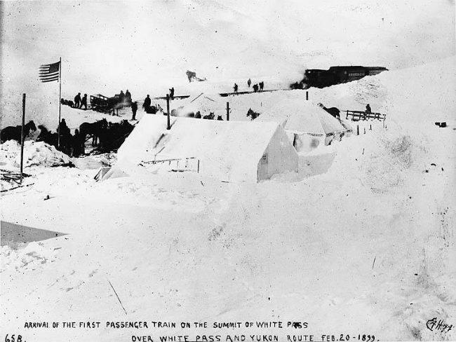 The scene of the celebration of the completion of the WP&YR railroad to the summit of the White Pass, February 20, 1899.
