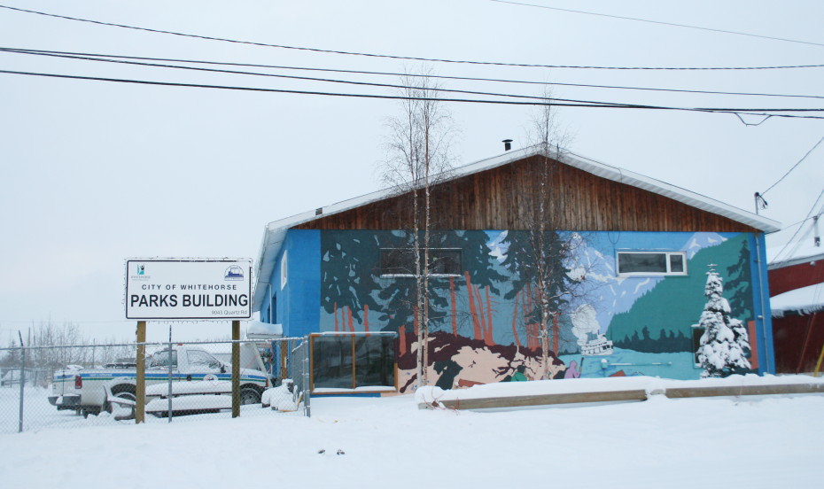 Mural showing a canoe and steamboat on a wilderness river, in Whitehorse, Yukon