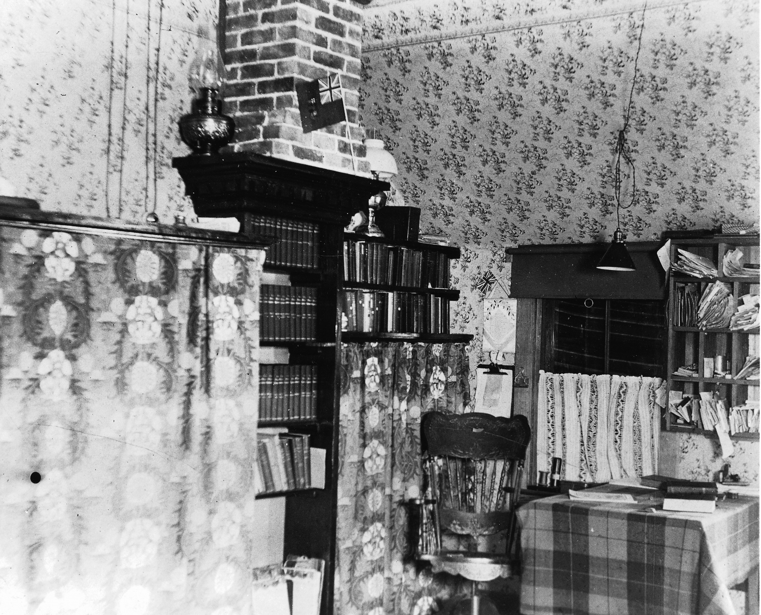 Library corner in a home, possibly at Whitehorse, Yukon Territory, 1900