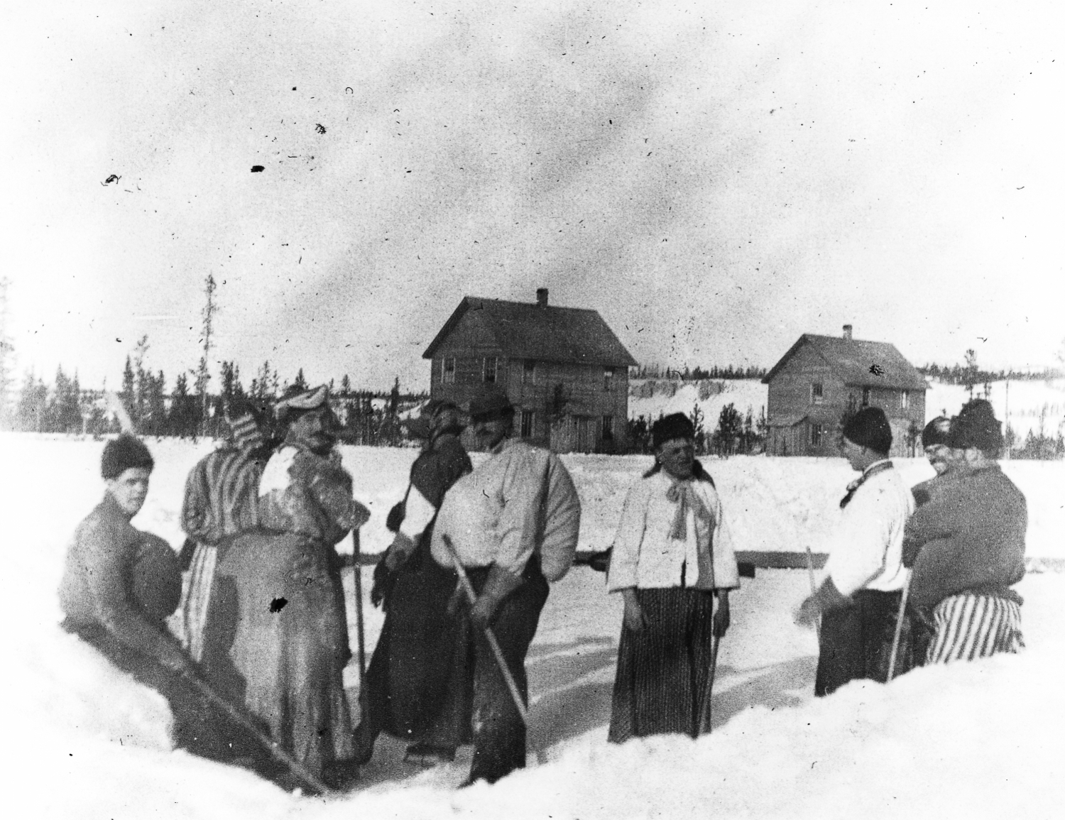 A hockey costume party on a rink at the Mounted Police headquarters at Whitehorse, 1900.